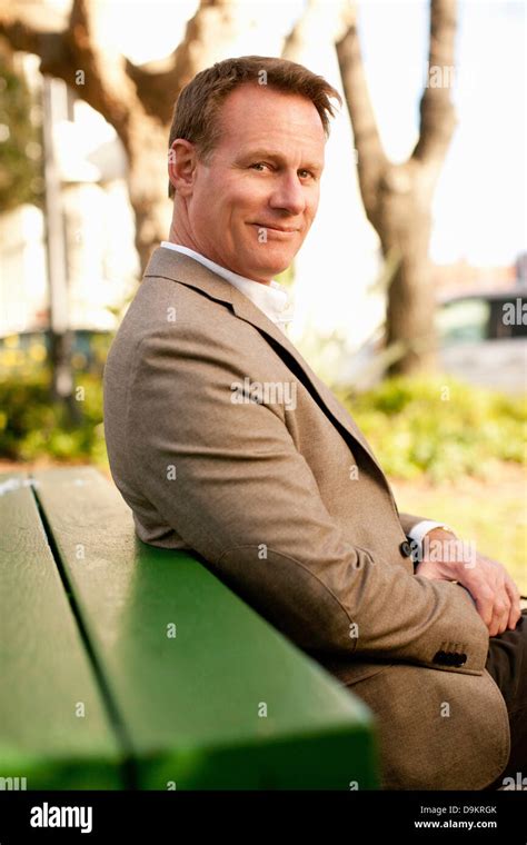 Man Sitting On Park Bench Stock Photo Alamy