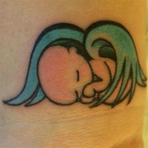 An Elephant Tattoo On The Side Of A Womans Leg With Blue Hair