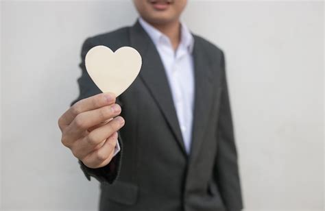 Premium Photo Businessman Giving A White Heart To A Customer On White