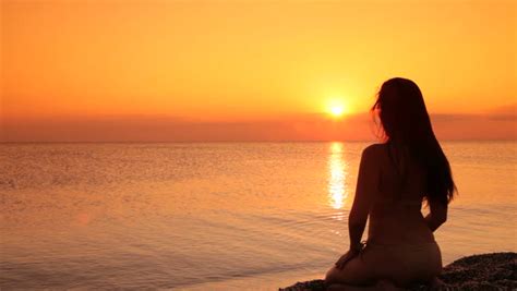 Silhouette Of A Woman Sitting On A Beach At Sunset Stock Footage Video Shutterstock