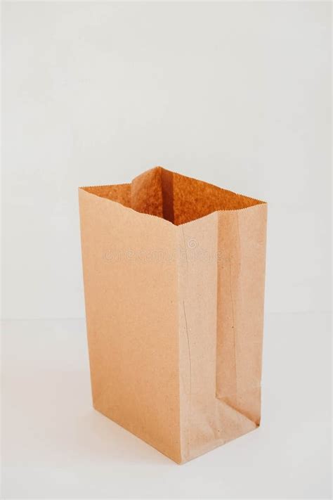 Open Disposable Package Made Of Brown Kraft Paper On A White Background