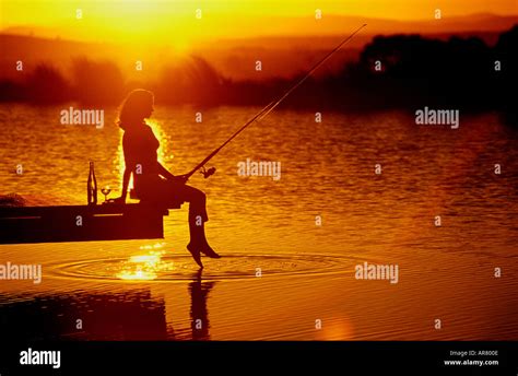Girl Fishing At Sunset Model Released Stock Photo Alamy
