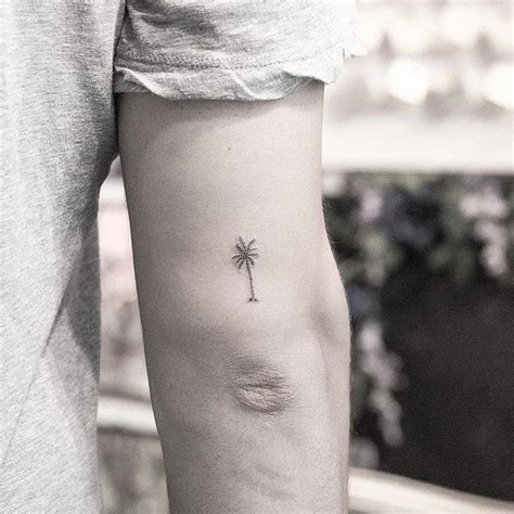 Tiny Palm Tree Tattoo On The Back Of The Right Arm