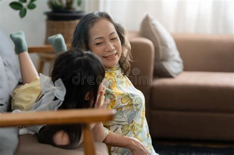 Happy Moments Of Asian Grandmother With Her Granddaughter Talking