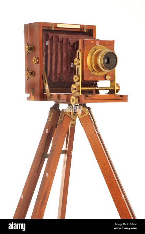 Very Old Camera On A Wooden Tripod On A White Background Stock Photo
