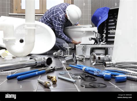 Plumber At Work In A Bathroom Plumbing Repair Service Assemble And Install Concept Stock Photo