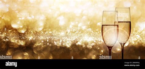 Champagne With Festive Gold Background And Shiny Bokeh Effects For A