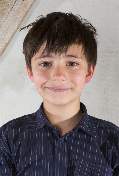 Portrait Of A Young Boy In Blue T Shirt On Blue Background Stock Photo