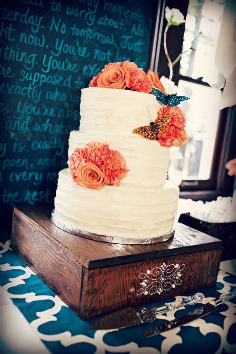 Orange And Teal Rustic Wedding Cake With Butterflies And Carnations