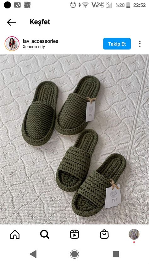 Three Green Slippers With Tags On Them Sitting On Top Of A White Bed Sheet