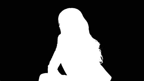 A White Silhouette Of A Female Model Spinning In A Seated Position On A