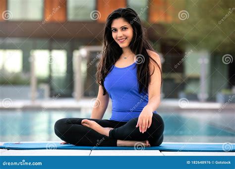 Beautiful Indian Woman Sitting With Legs Crossed Outside Her House