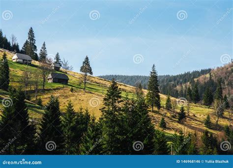 Landscape Of Green Mountain Hills Covered By Forest With Small Houses
