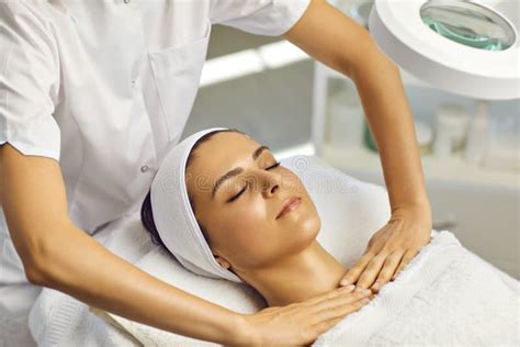 Cosmetologist Or Masseur Making Facial Massage With Upper Shoulder Girdle For Woman In Beauty
