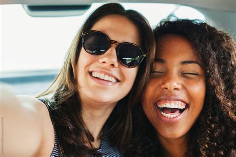 Happy Multiethnic Female Friends Taking A Selfie Inside A Car By