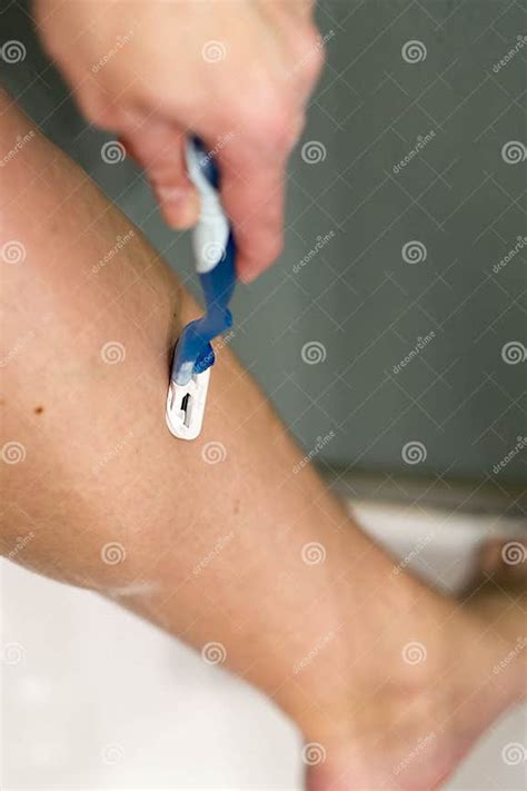 Woman Shaving Her Legs Woman In The Shower Shaves Young Woman Shaving Her Leg In Shower Cabin