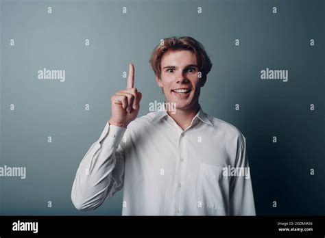 Young Man Pointing And Forefinger Index Finger Up Stock Photo Alamy