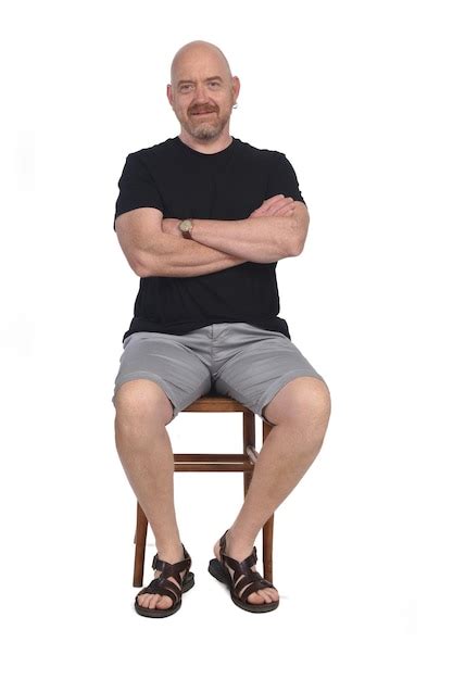 Premium Photo Bald Man With Sandals T Shirt And Shorts Sitting On