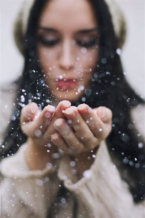 Young Woman Blowing Handful Of Snow By Stocksy Contributor Jovana