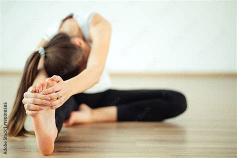 Woman Practicing Yoga Sitting In Head To Knee Forward Bend Exercise