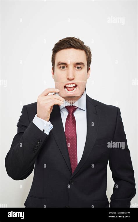 Businessman Holding Picture Over His Mouth Stock Photo Alamy