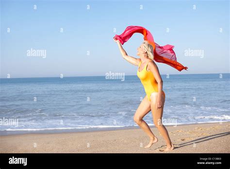 Senior Woman Running On Beach Stock Photo Alamy