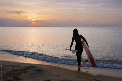 Back View Of Woman With Paddle Board Walking Into Sea By Stocksy Contributor Guille Faingold