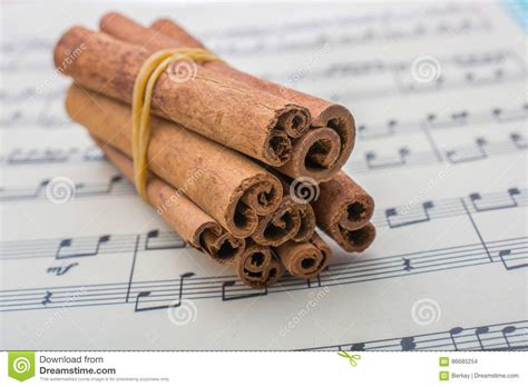 Bundles Of Cinnamon Sticks On Musical Notes Stock Photo Image Of