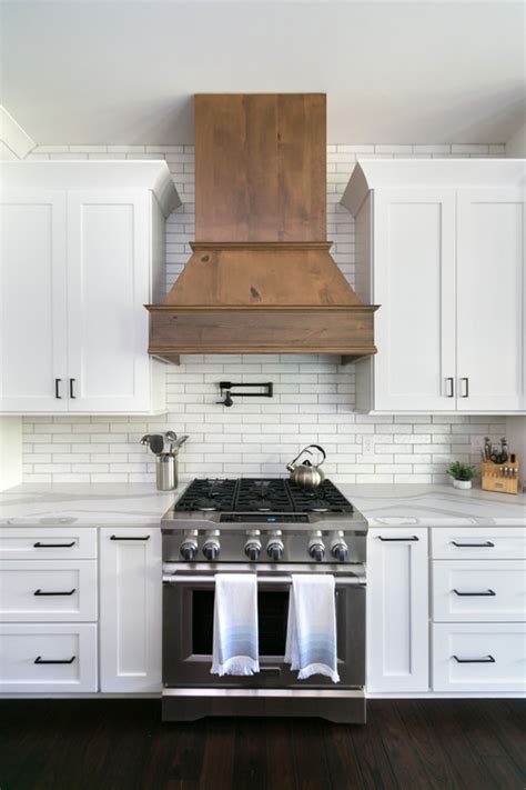 A range hood above the stove is the epitome of a farmhouse kitchen. White and Wood Modern Farmhouse Kitchen Ideas - Pickled Barrel