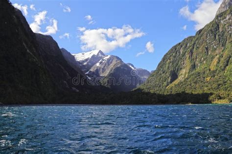 Scenic Landscape Featuring Blue Waters Surrounded By Mountains Milford