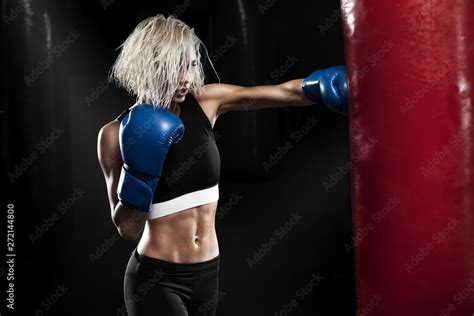 Female Boxer Hitting A Punching Bag At A Boxing Studio Woman Boxer
