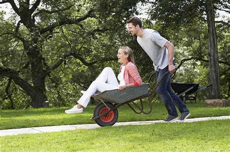 Man Pushing Woman In Wheelbarrow Background Fun Having Happy Background Image For Free Download