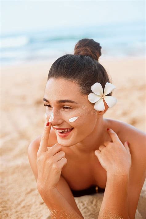 Sun Protection Beautiful Woman In Bikini Applying Sun Cream On Tanned Shoulder Stock Image