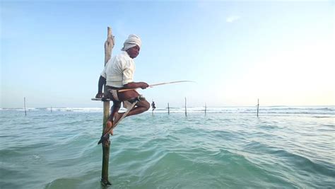 Galle Sri Lanka March 2014 Old Fisherman On A Fishing Pole In The