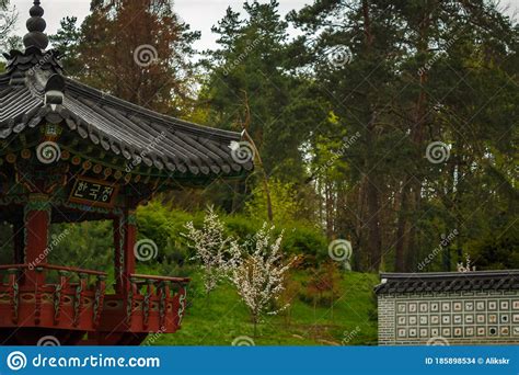 Japanese Style Wooden Gazebo In A Blooming Cherry Garden Stock Photo