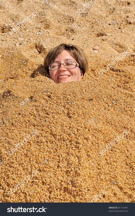 Head Of A Woman Buried In The Sand Stock Photo 81113491