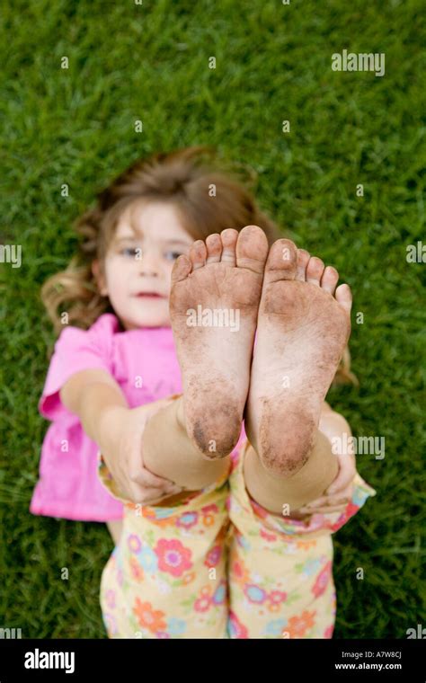 Close Up Of 4 Years Old Girls Dirty Feet Tree Park Public Park