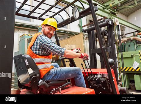 Forklift drivers driving forklifts in the warehouse of a factory or