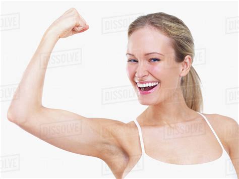 Woman Flexing Biceps Stock Photo Dissolve