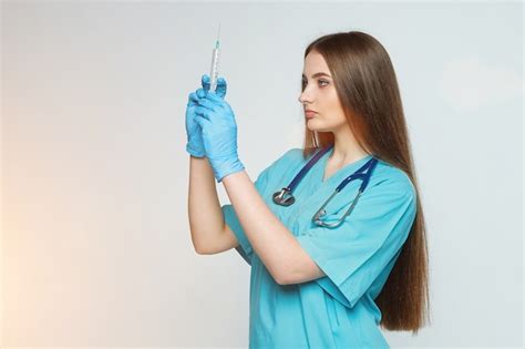 Premium Photo Female Doctor Holds A Syringe In Her Hand