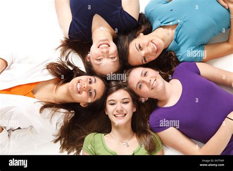 A Group Of Five Girls Having Fun Hanging Out Making A Circle On The