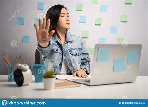 Asian Woman Working On A Laptop Showing Hand Making Stop Sign At Home Office Wfh Work From