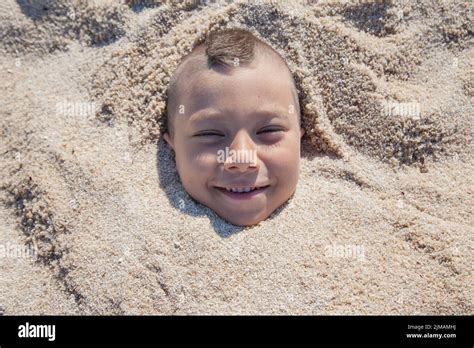 Child Face Buried Sand Stock Photo Alamy