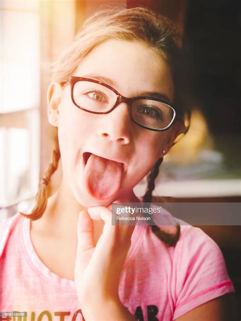 10 Year Old Girl In Pigtail Braids Sticking Out Her Tongue Photo