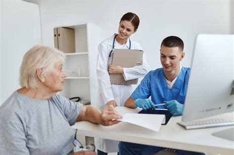 Elderly Woman Patient At Hospital Appointment Nurse And Doctor Health