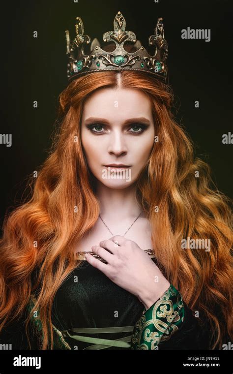 Red Haired Woman In A Green Medieval Dress Near The Castle Stock Photo