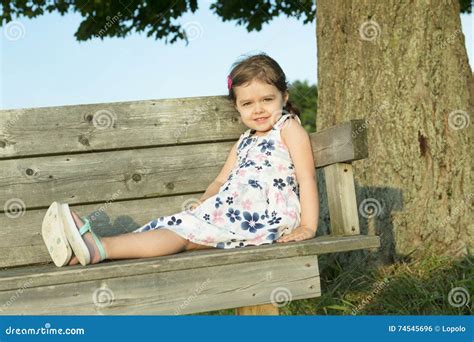 Happy Cute Little Girl Sitting On A Bench Stock Photo Image Of Face