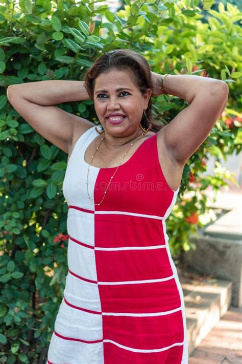 hispanic woman in dress cell phone in hand looking at camera stock image image of holding