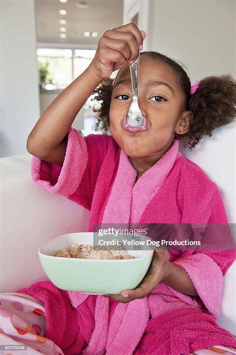 Young Girl Eating Cereal High Res Stock Photo Getty Images