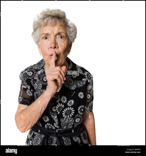 Senior Woman Shushing Camera Stock Photo Alamy